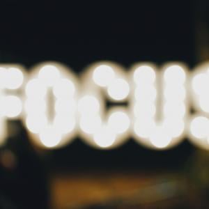 a lit sign that says "focus"
