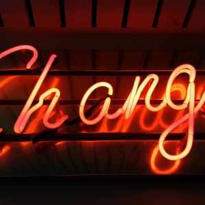 a neon sign that says the word "change"