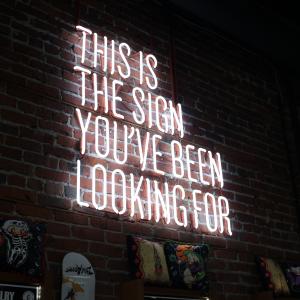 a neon sign with the words "this is the sign you've been looking for" on it