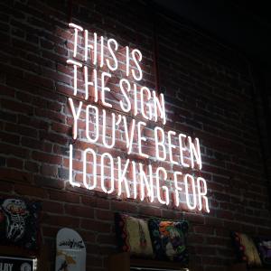 a neon sign with the words "this is the sign you've been looking for" on it