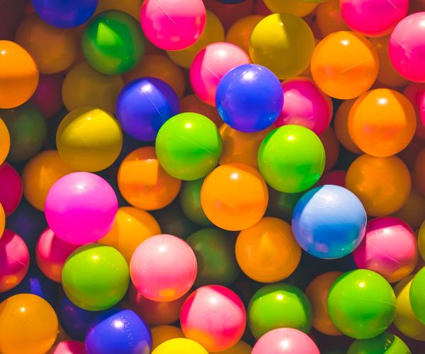 a ball pit with various colors of plastic balls together