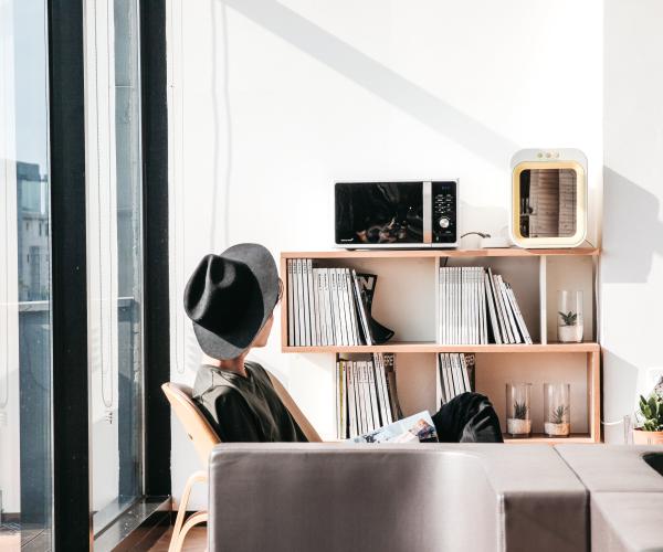 person sitting in a chair in an aesthetically pleasing living room