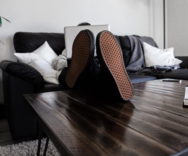 person using a laptop sitting on a couch