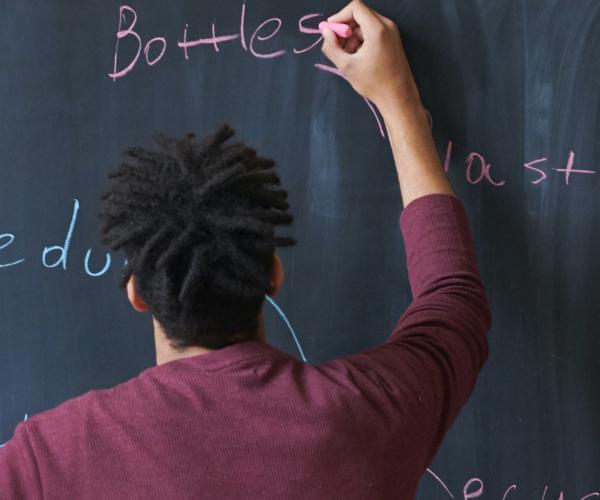 3 people writing on a chalkboard