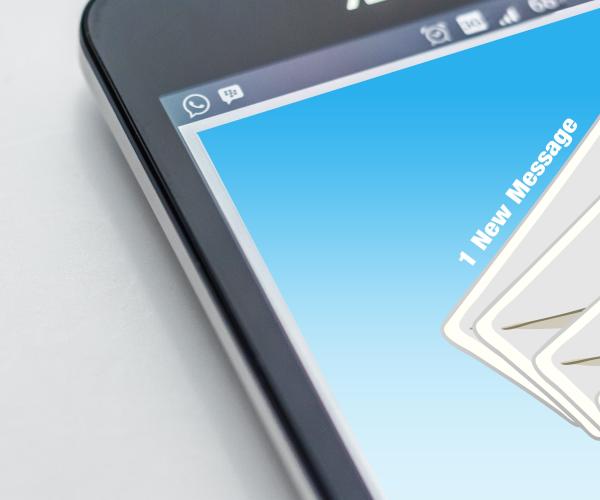 a mobile phone with envelope icons cascading down the side of the screen