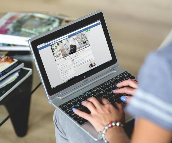 a person typing on a laptop in their lap