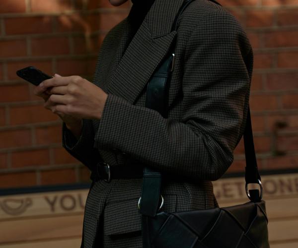 Woman walking while staring at her phone.