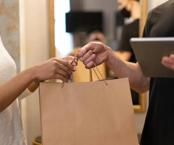One person handing off a bag to another.