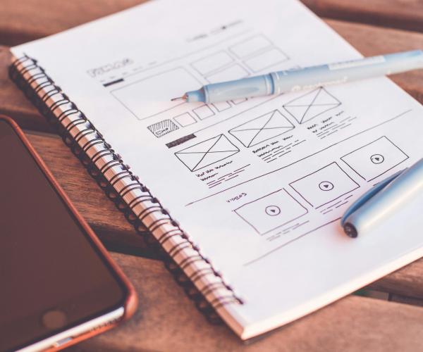 Sketch of a website layout in a notepad.