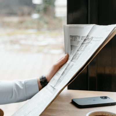 Person reading a newspaper.