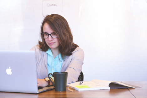 Woman sitting at a desk working on her laptop