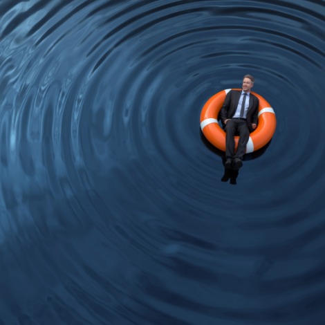 Man floating in water in a life preserver 