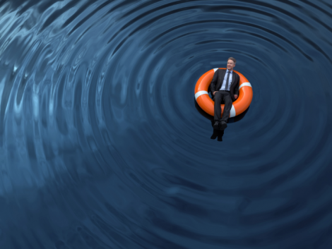 Man floating in water in a life preserver 