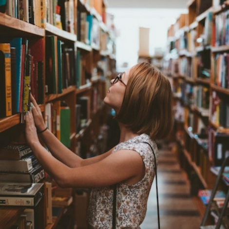 Student browsing books in a library