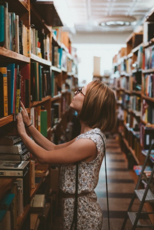 Student browsing books in a library