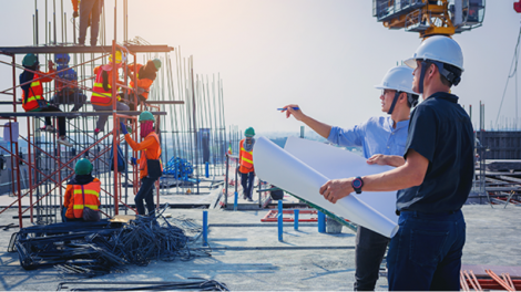 Two workers discussing building plans