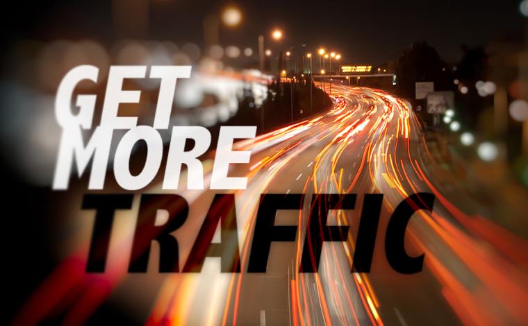 slow shutter speed shot of a freeway to make the car lights look like long lines. overlayed on top of the image in bold text says "get more traffic"