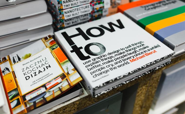 a stack of books and the main focus is a book that says "how to" in large text
