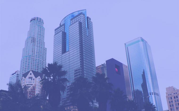 a few various skyscraper buildings in los angeles. the whole image is tinted lavender.