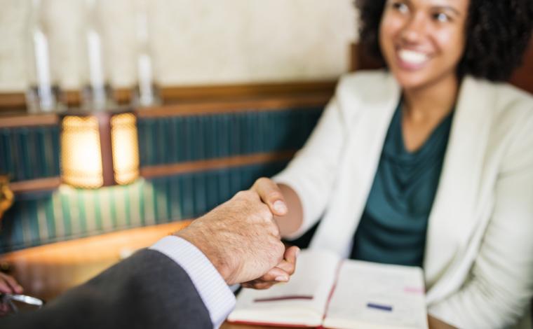 woman shaking hands with a business man
