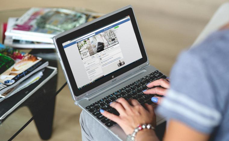 a person typing on a laptop in their lap