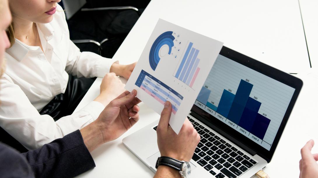 Two people going over different graphs